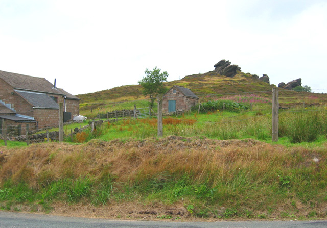 Gritstone outcrop near Hazel Barrow. One of several small gritstone outcrops on a minor elevation near Hazel Barrow and Newstone Farm. The building in the left foreground, at a T-j